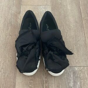 J Slides black bow ruffle top sneaker.